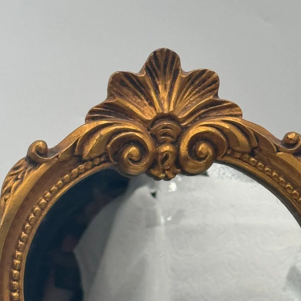 French-style ornate wall mirror, rococo or baroque decorative elements in a gil